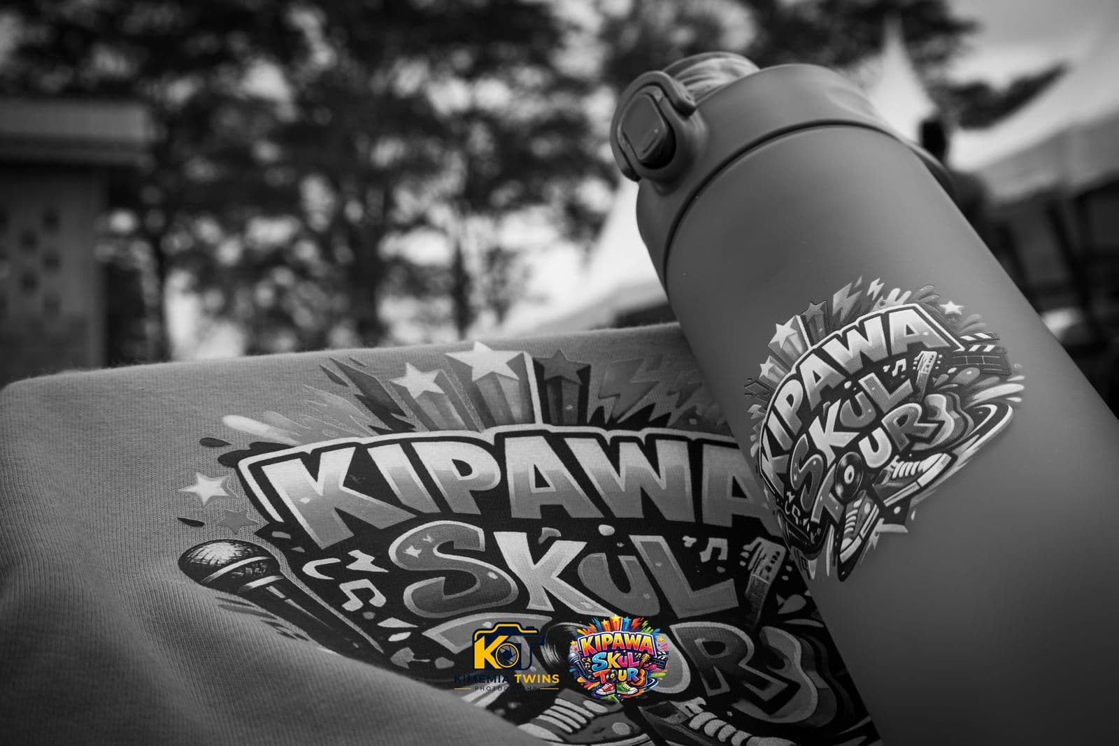 Kipawa Skul Tour branded bottle and shirt, black and white photo