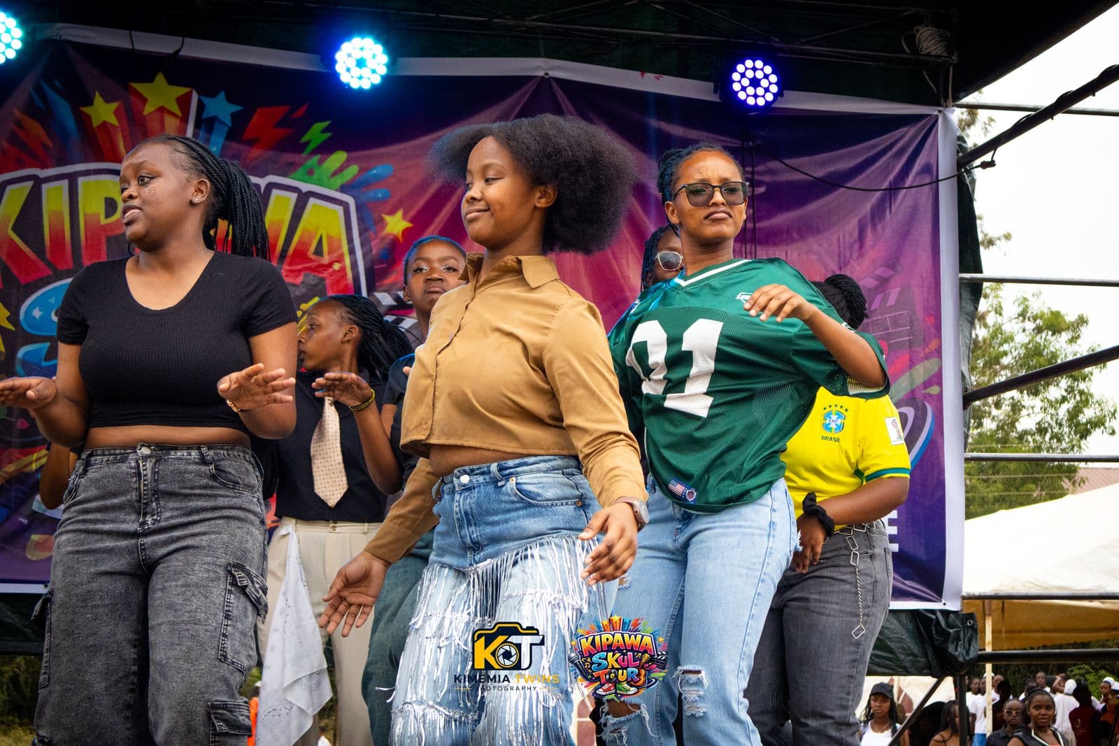 Students dancing on the Kipawa Skul Tour stage under blue stage lights